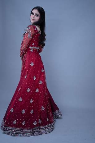 Bride in a scarlet gown with silver work