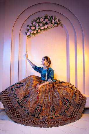 Bride in a teal and gold lehenga